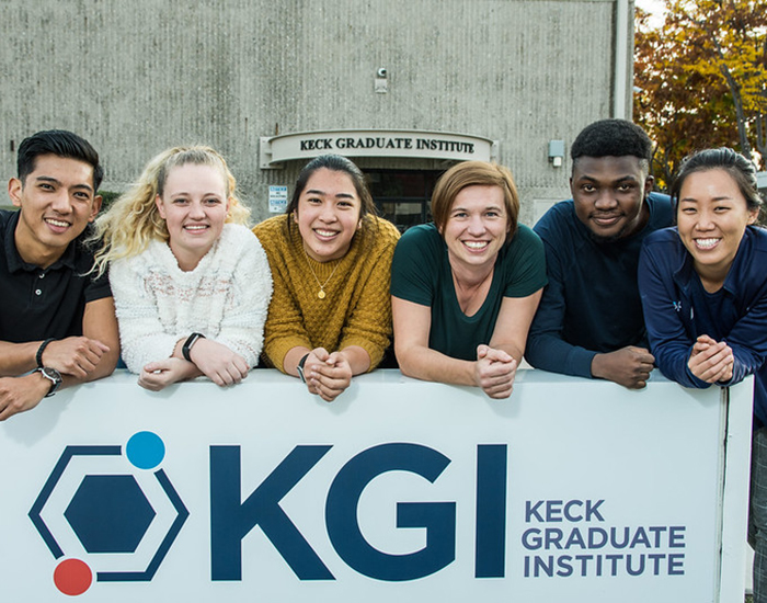 group of students smiling in front of KGI sign