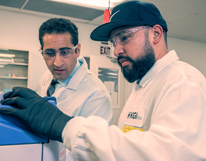 male MEng students in lab using equipment